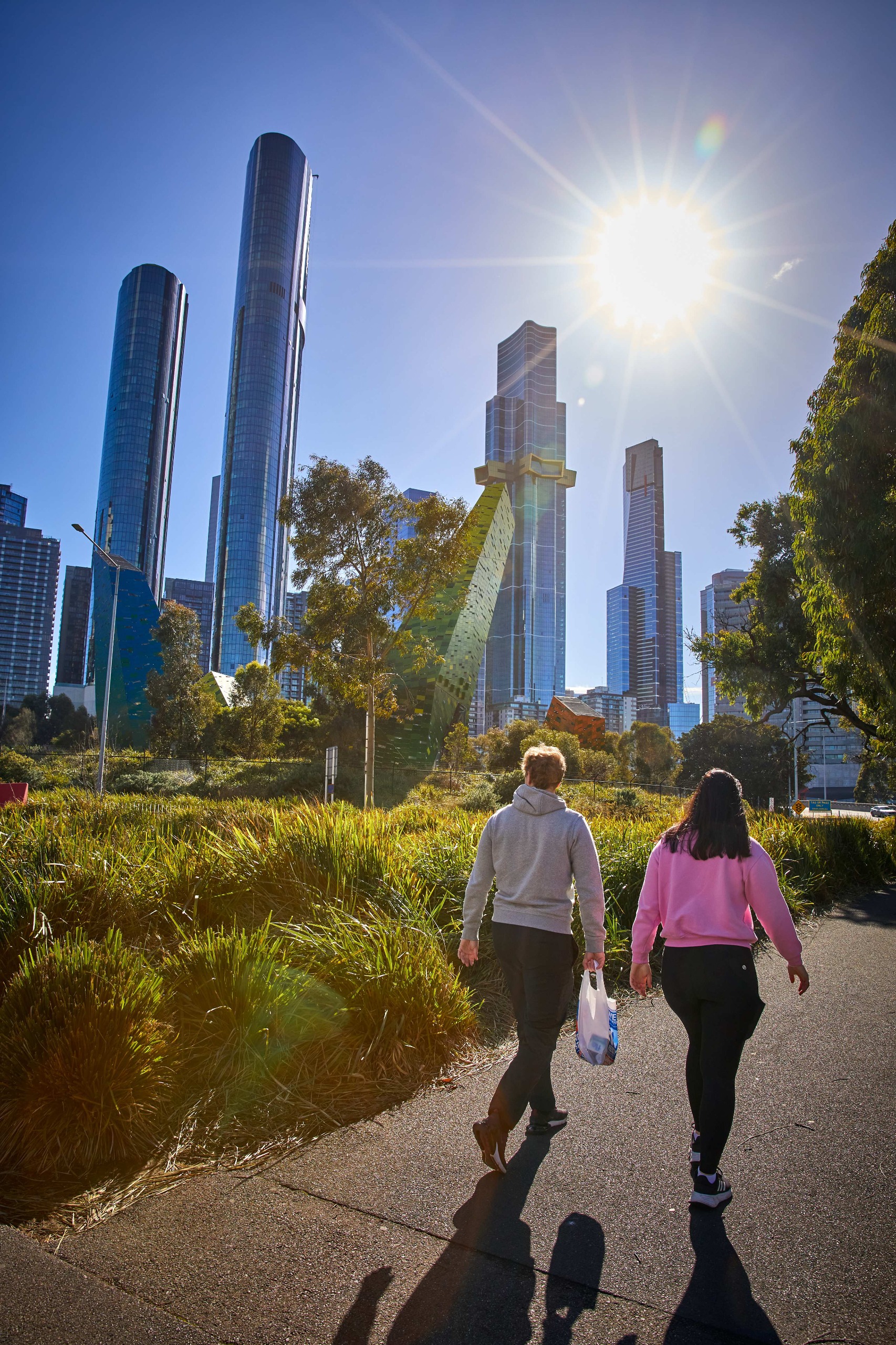 people walking in southbank near tall apartment buildings