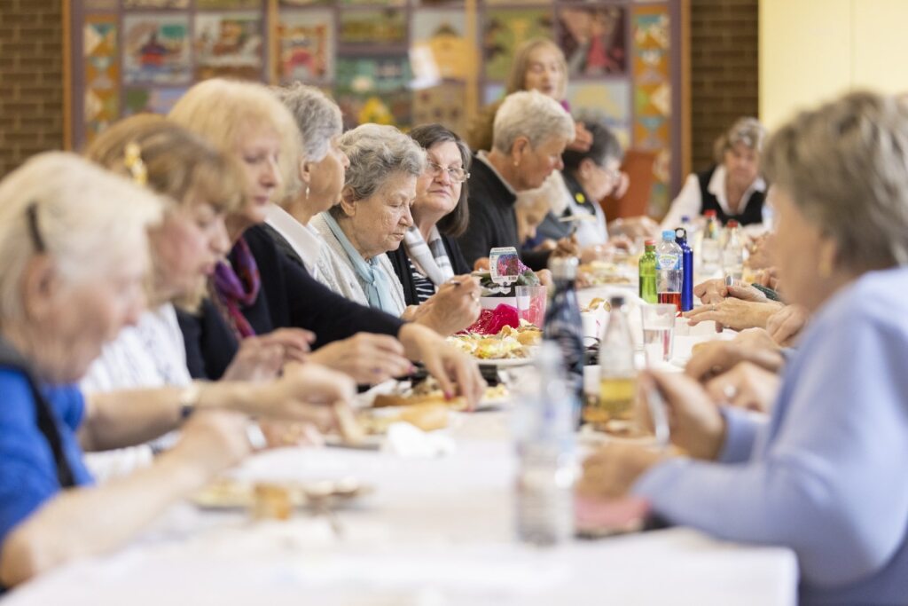 people sitting at large table eating 