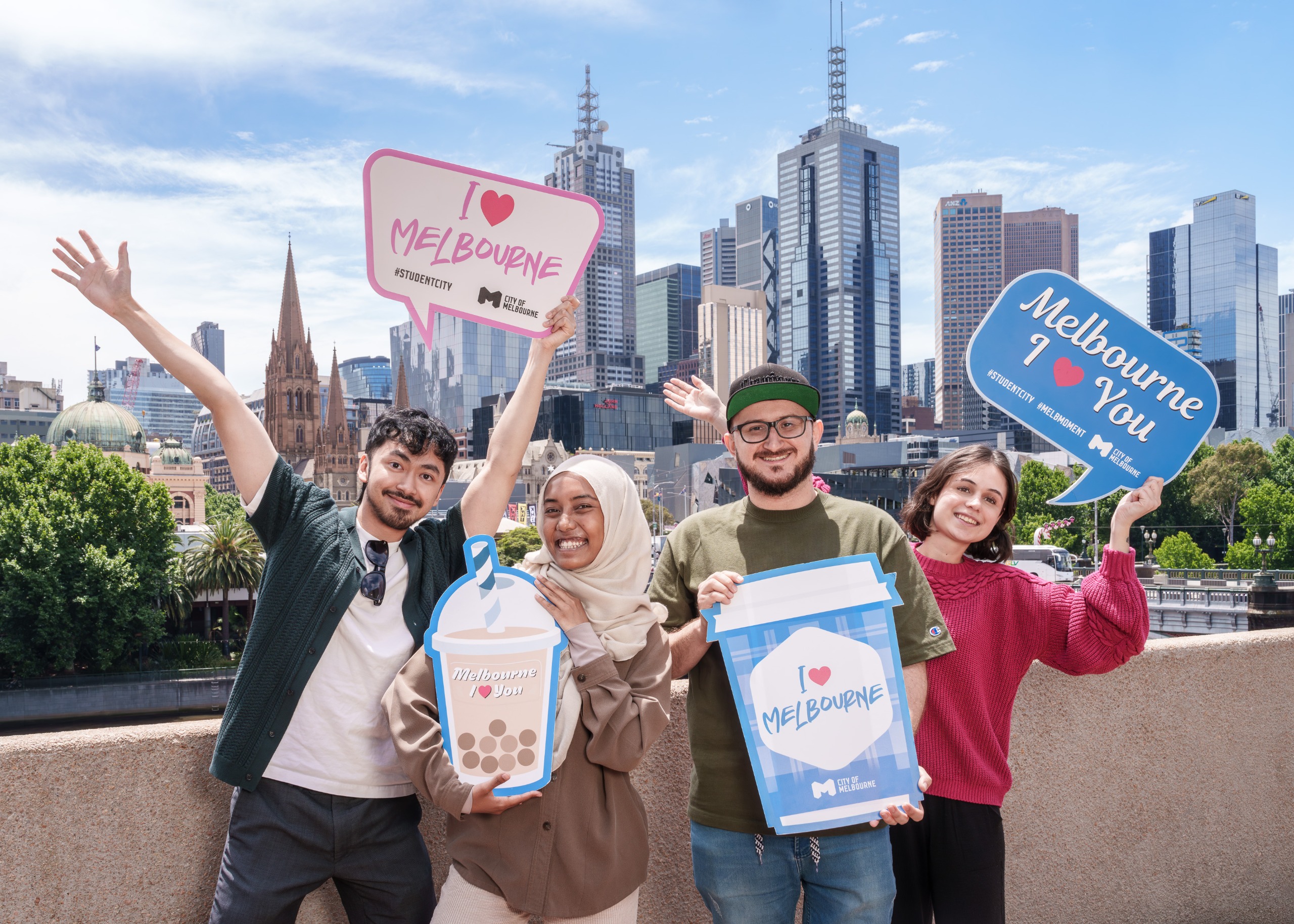 students in the city of Melbourne holding I love Melbourne signs. 