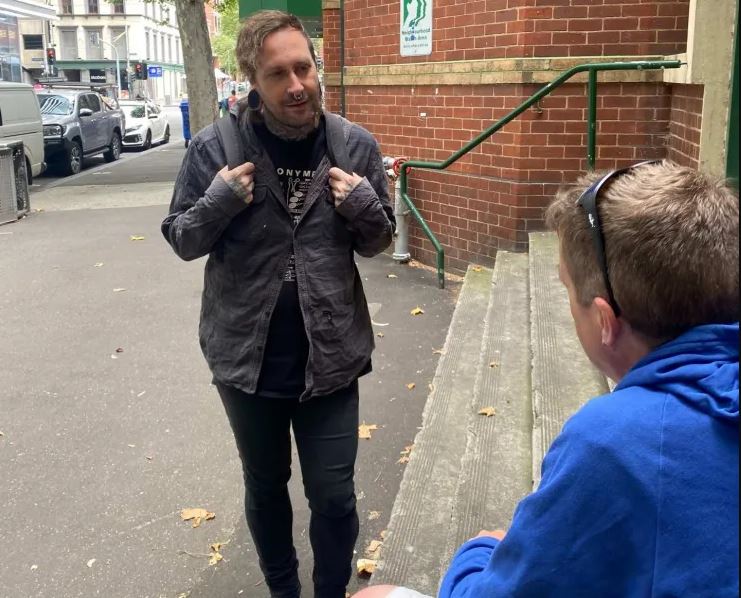Person speaking to someone on the street