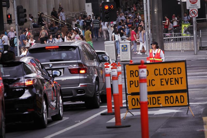 Traffic controller on road with traffic and cars. 