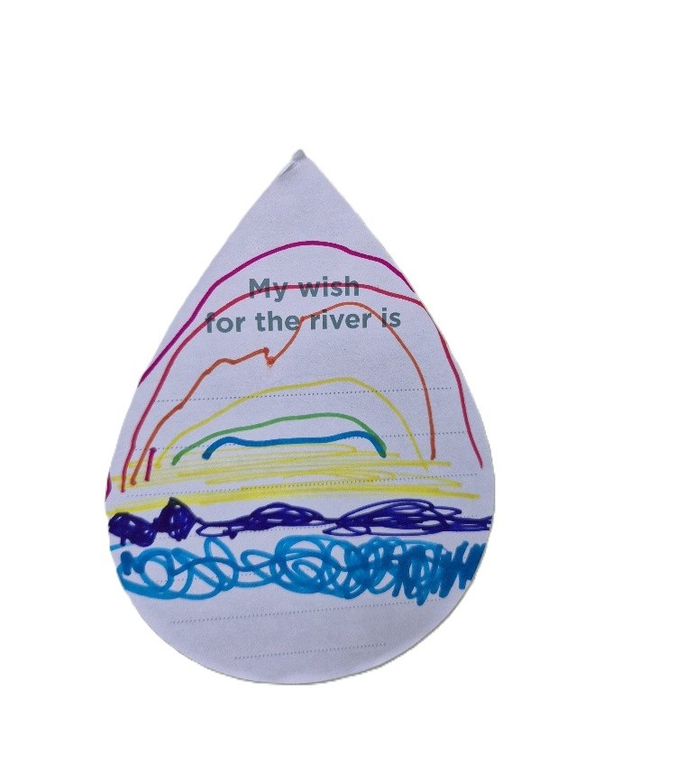 Child's drawing of a rainbow over the river.