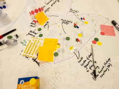 A map of North and West Melbourne on a table with pens, stickers and post it notes. 