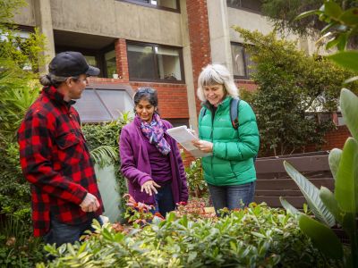 Garden Guides visiting an apartment building common space garden